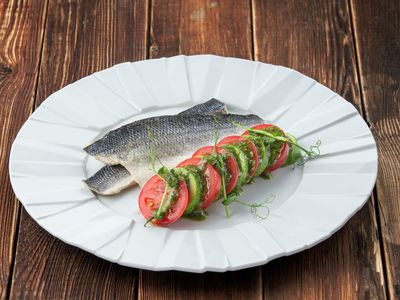 Steamed sea bass with zucchini tomatoes and pesto sauce