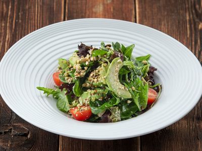 Green salad with spinach, avocado, green buckwheat sprouts and seeds